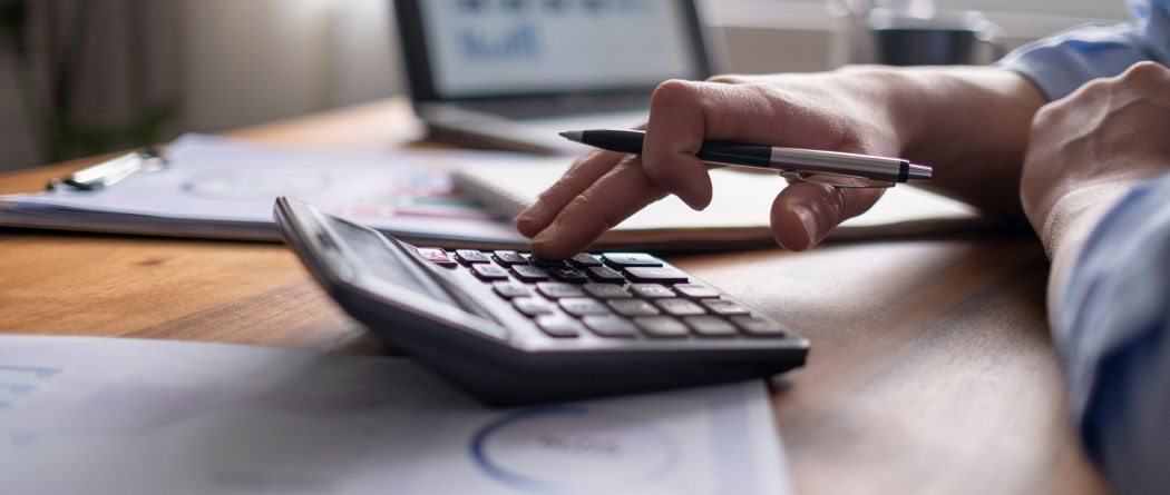 close-up of a hand using a calculator