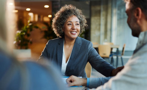 business woman sitting across from people slightly out of frame