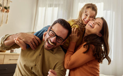 young family together in a living room